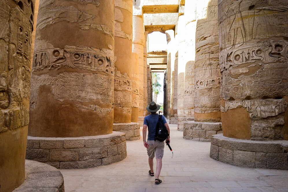a-young-man-walking-in-a-egyptian-temple_181624-44493