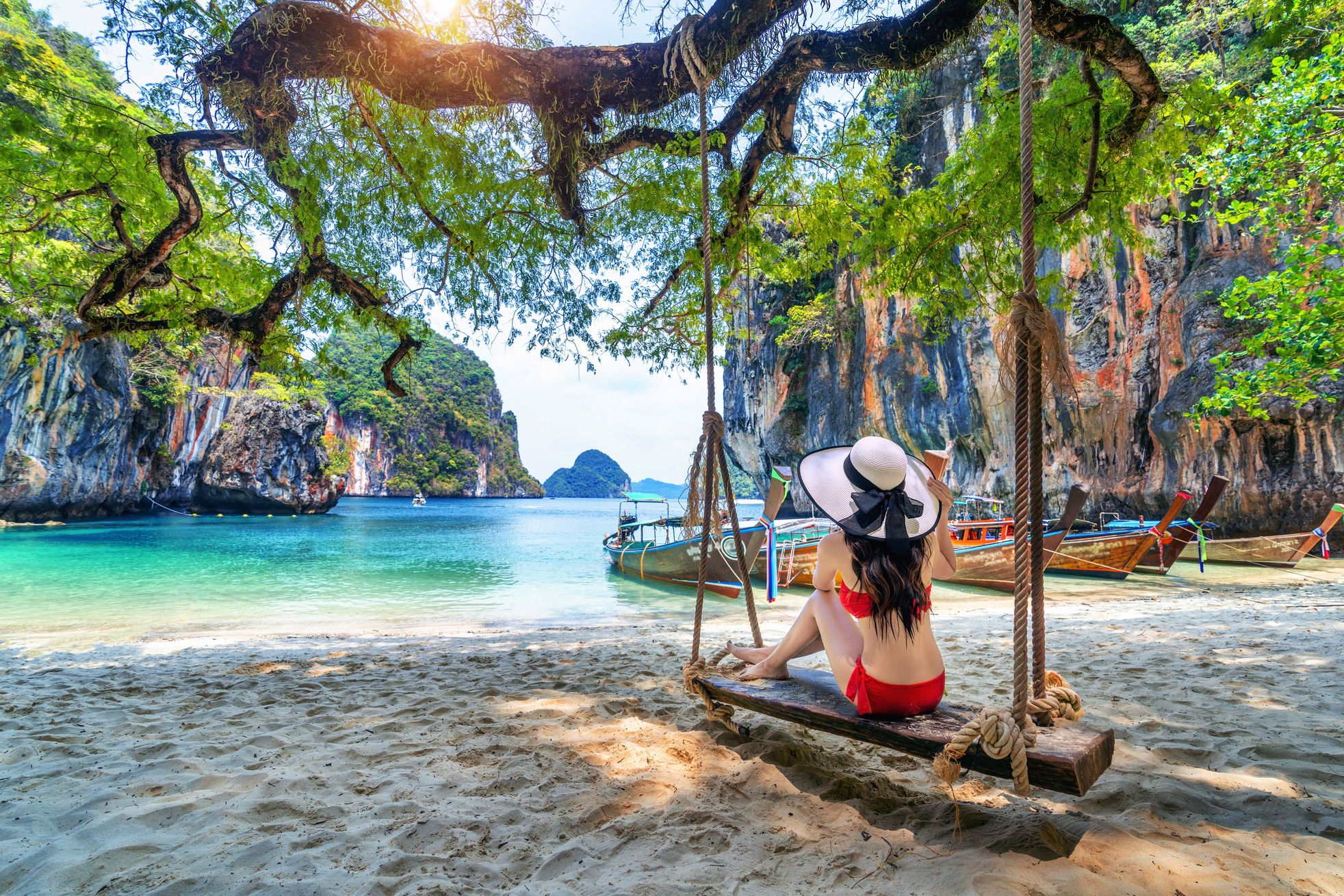 woman in bikini relaxing on swing at ko lao lading island krabi thailand